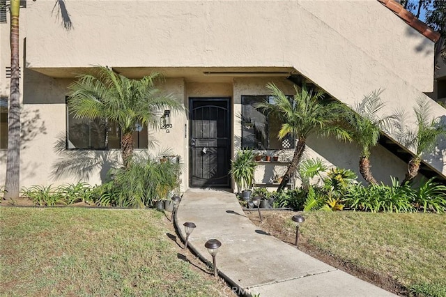 383 N Melrose Dr Unit G, Vista, CA 92083 - property entrance with stucco siding and a yard