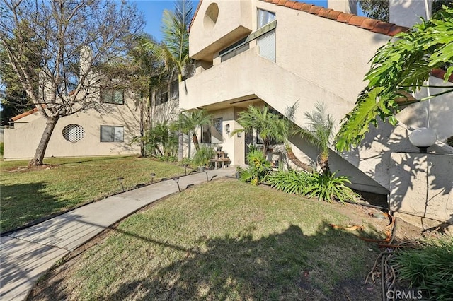 383 N Melrose Dr Unit G, Vista, CA 92083 - view of front of property featuring stucco siding, a front yard, and a tile roof