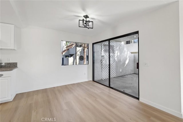 383 N Melrose Dr Unit G, Vista, CA 92083 - unfurnished dining area with light wood finished floors and baseboards