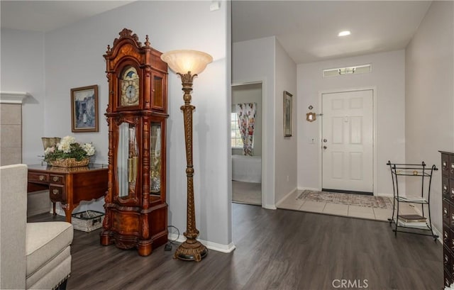 entryway featuring wood finished floors, baseboards, and recessed lighting