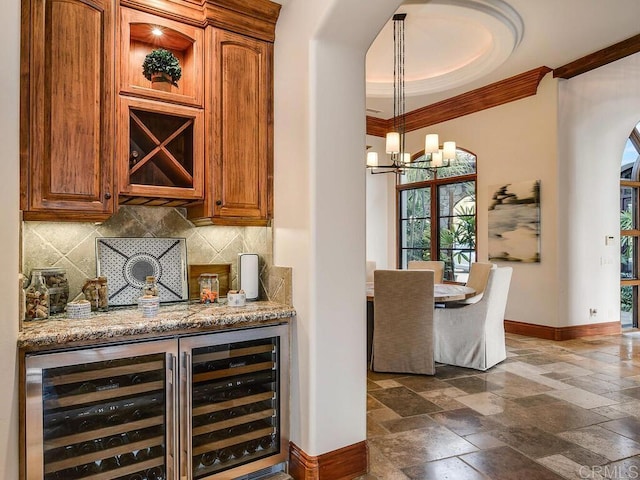 18414 Calle La Serra, Rancho Santa Fe, CA 92091 - indoor dry bar with baseboards, ornamental molding, stone tile flooring, backsplash, and beverage cooler