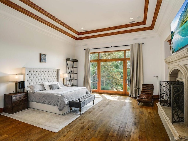 18414 Calle La Serra, Rancho Santa Fe, CA 92091 - bedroom with hardwood / wood-style floors, ornamental molding, a tray ceiling, a fireplace with raised hearth, and access to outside