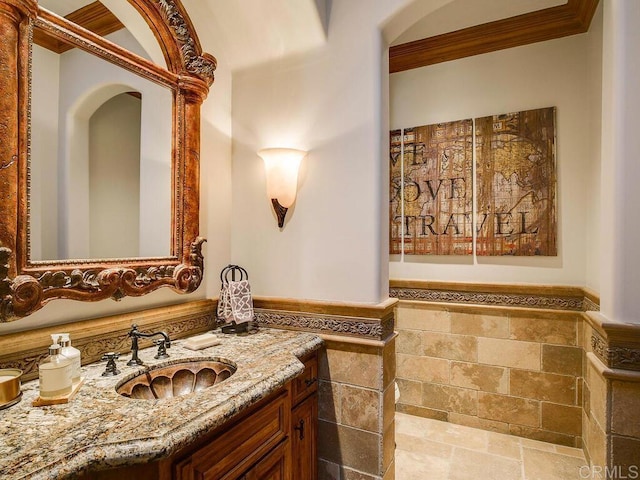 18414 Calle La Serra, Rancho Santa Fe, CA 92091 - bathroom with stone tile floors, vanity, and ornamental molding