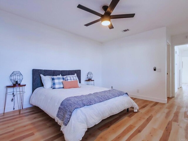 1025 Plover Way, Oceanside, CA 92057 - bedroom with light wood-style floors, a ceiling fan, and baseboards