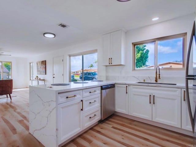 1025 Plover Way, Oceanside, CA 92057 - kitchen with dishwasher, a sink, white cabinets, healthy amount of natural light, and recessed lighting