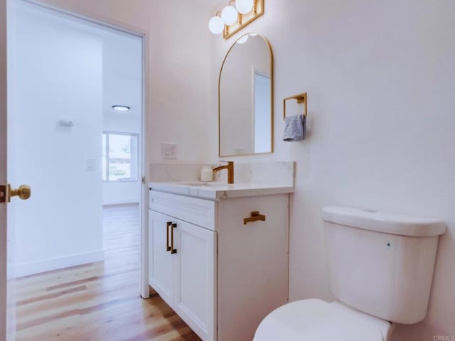 1025 Plover Way, Oceanside, CA 92057 - half bathroom with wood finished floors, vanity, and toilet