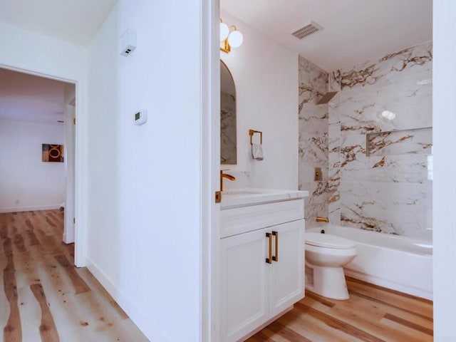 1025 Plover Way, Oceanside, CA 92057 - bathroom featuring wood finished floors, toilet, vanity, and tub / shower combination