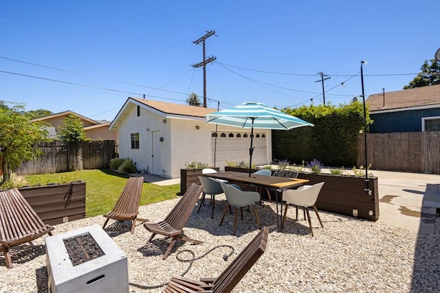 1305 Cosmic Way, Glendale, CA 91201 - view of patio / terrace with an outdoor fire pit, an outbuilding, a fenced backyard, and a detached garage