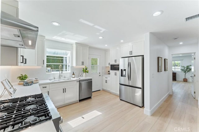 18011 Theodora Dr, Tustin, CA 92780 - kitchen featuring stainless steel appliances, a sink, light countertops, white cabinets, and recessed lighting