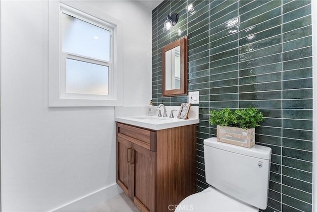 18011 Theodora Dr, Tustin, CA 92780 - half bath with tile walls, vanity, toilet, and baseboards