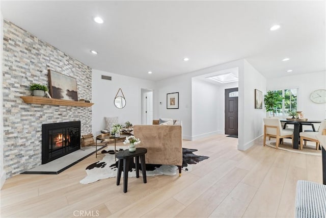 18011 Theodora Dr, Tustin, CA 92780 - living area with light wood finished floors, a stone fireplace, recessed lighting, and baseboards