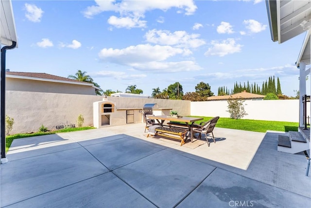 18011 Theodora Dr, Tustin, CA 92780 - view of patio / terrace with exterior kitchen, a fenced backyard, and outdoor dining space