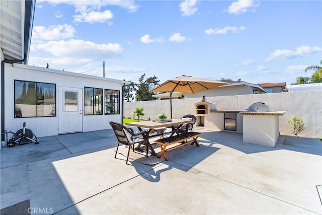 18011 Theodora Dr, Tustin, CA 92780 - view of patio with exterior kitchen, fence, and outdoor dining space