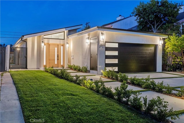 modern home featuring a front yard and stucco siding
