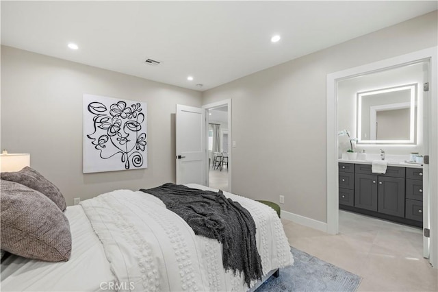 bedroom with recessed lighting, ensuite bath, baseboards, a sink, and light tile patterned floors