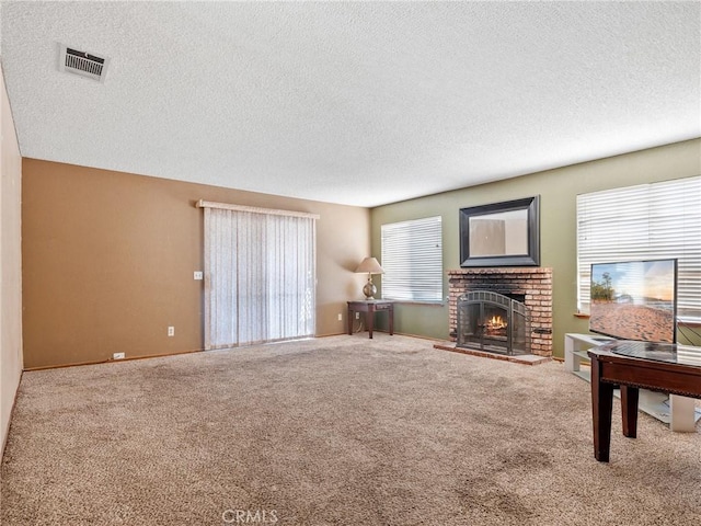 17949 Catalpa St, Hesperia, CA 92345 - carpeted living room featuring a textured ceiling, a brick fireplace, and baseboards