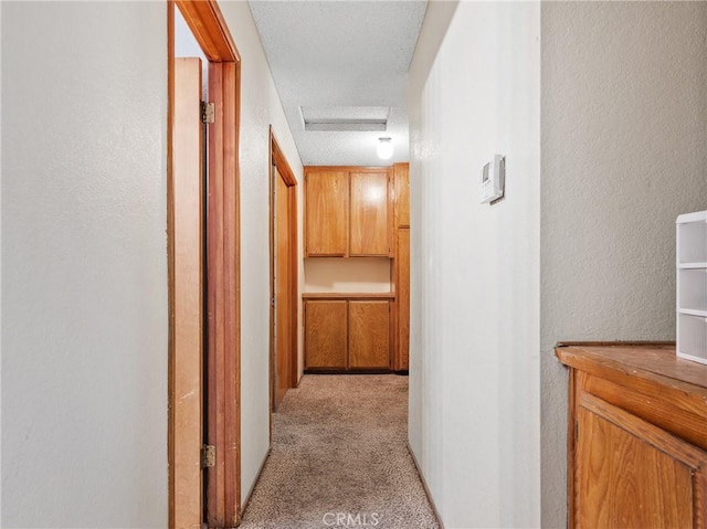 17949 Catalpa St, Hesperia, CA 92345 - corridor featuring attic access, light carpet, and a textured wall