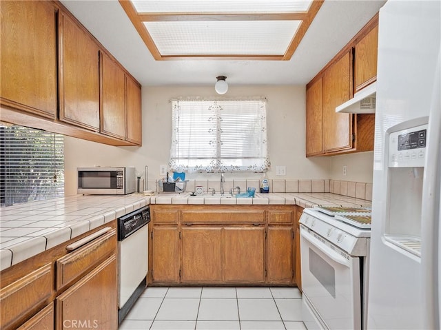 17949 Catalpa St, Hesperia, CA 92345 - kitchen with white appliances, under cabinet range hood, a sink, and healthy amount of natural light