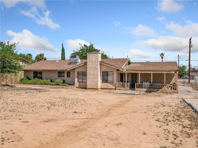 17949 Catalpa St, Hesperia, CA 92345 - rear view of house featuring a chimney, central air condition unit, and stucco siding