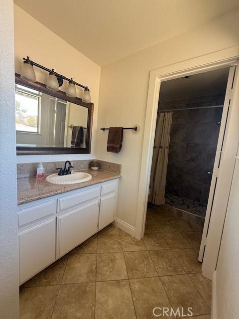 17949 Catalpa St, Hesperia, CA 92345 - full bath with vanity, tile patterned flooring, and tiled shower