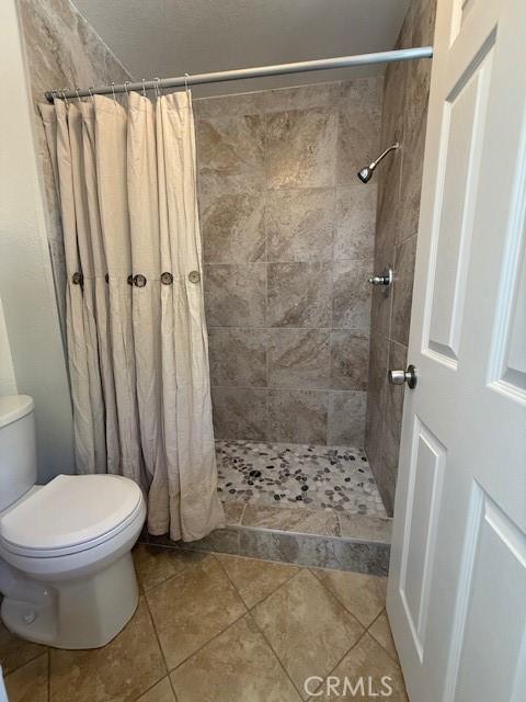 17949 Catalpa St, Hesperia, CA 92345 - full bathroom with tiled shower and tile patterned flooring