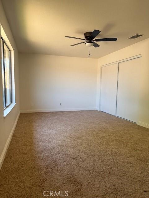 17949 Catalpa St, Hesperia, CA 92345 - unfurnished bedroom featuring carpet flooring, a closet, and ceiling fan