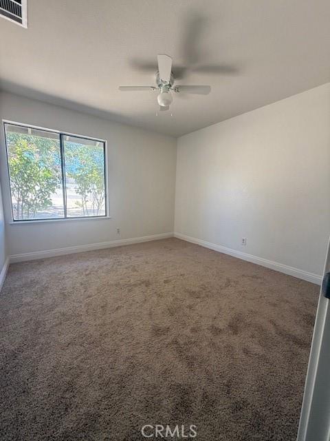 17949 Catalpa St, Hesperia, CA 92345 - empty room with a ceiling fan and carpet floors