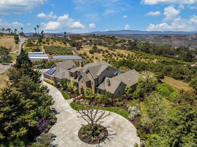 aerial view of property and surrounding area with a mountain backdrop