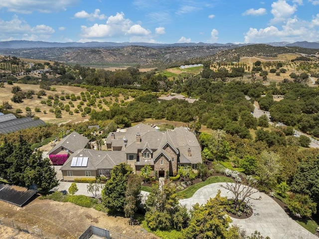 aerial view of property and surrounding area featuring mountains