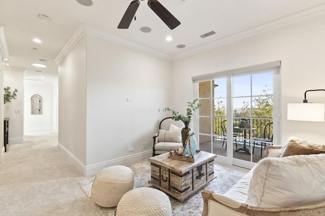 sitting room with a ceiling fan, baseboards, light colored carpet, crown molding, and recessed lighting