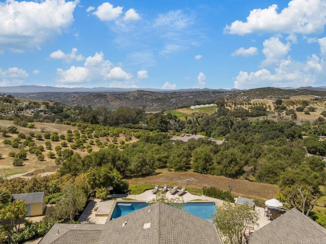 aerial view of property and surrounding area featuring a mountain backdrop