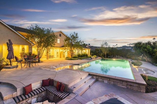 outdoor pool with a patio area