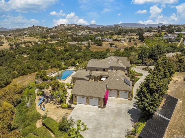 view of subject property with a pool and mountains