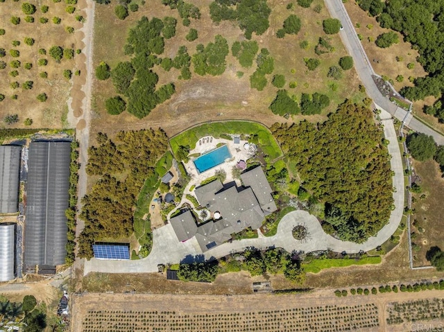 aerial view of property and surrounding area with a pool area