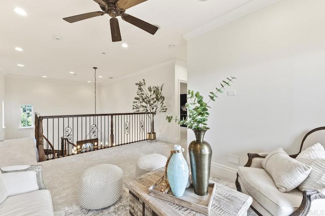 living room featuring ceiling fan, carpet, ornamental molding, recessed lighting, and baseboards