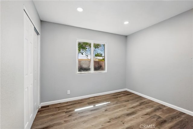 43820 Beech Ave, Lancaster, CA 93534 - unfurnished bedroom with a closet, wood finished floors, baseboards, and recessed lighting