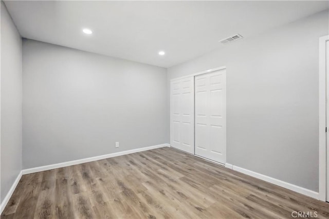 43820 Beech Ave, Lancaster, CA 93534 - unfurnished bedroom featuring wood finished floors, a closet, baseboards, and recessed lighting