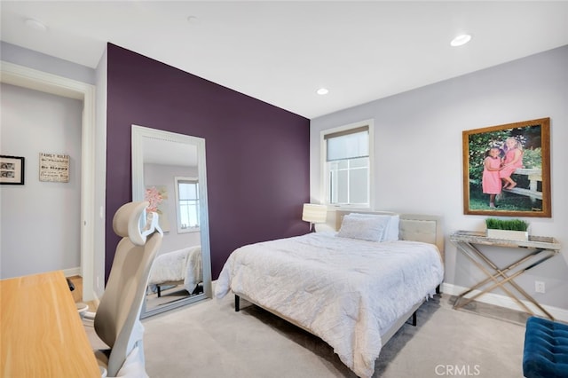 carpeted bedroom featuring baseboards and recessed lighting