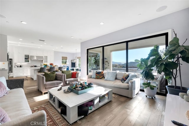 living room featuring light wood finished floors and recessed lighting