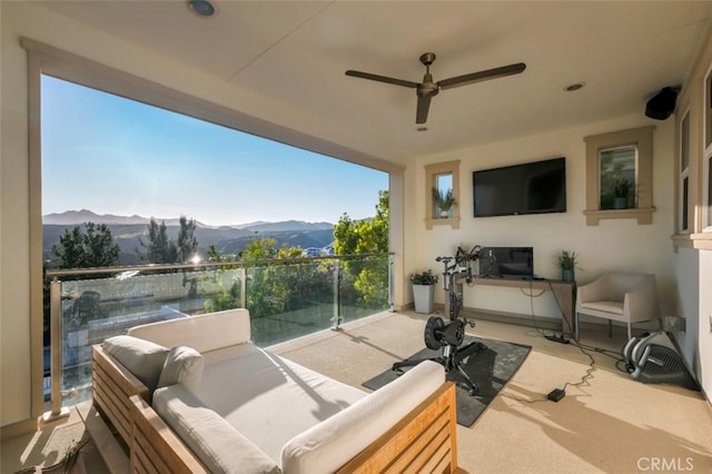 balcony with an outdoor living space and a ceiling fan