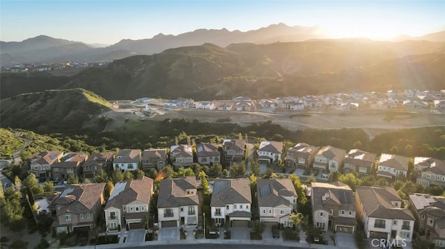 aerial view of property and surrounding area with nearby suburban area and a mountain backdrop