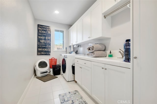 laundry room featuring cabinet space, independent washer and dryer, baseboards, and light tile patterned floors