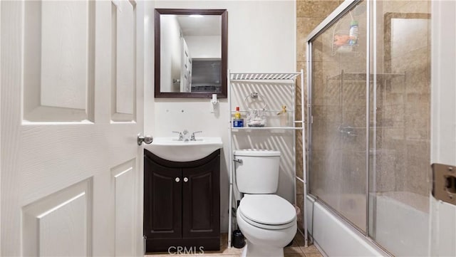 full bathroom with vanity, combined bath / shower with glass door, and toilet