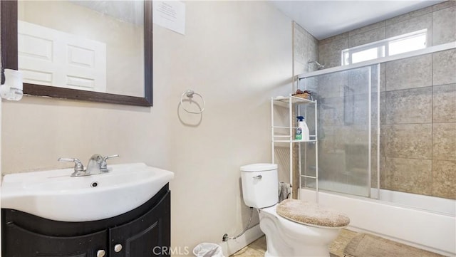 full bathroom with toilet, enclosed tub / shower combo, and vanity