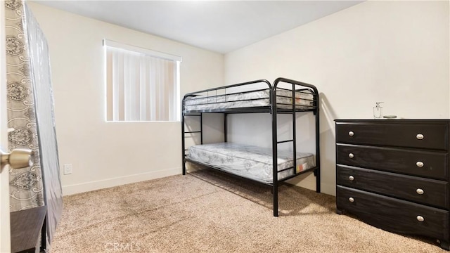 bedroom with carpet and baseboards