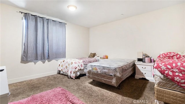 carpeted bedroom with baseboards
