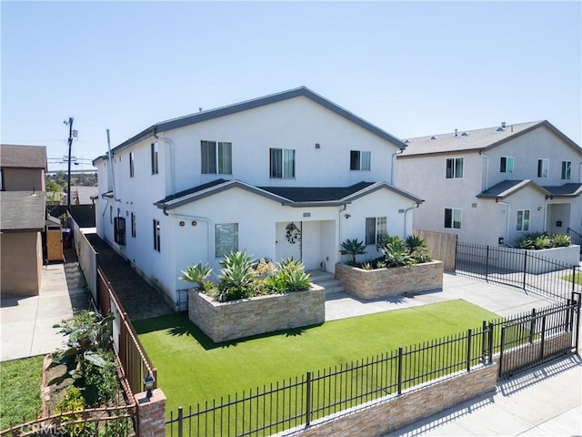 rear view of property featuring stucco siding