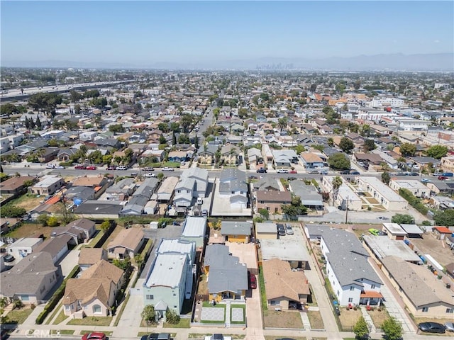 aerial view of property's location featuring nearby suburban area and a mountainous background
