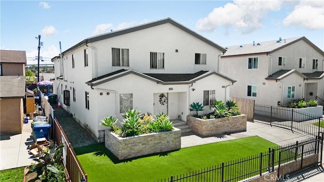 rear view of property featuring stucco siding