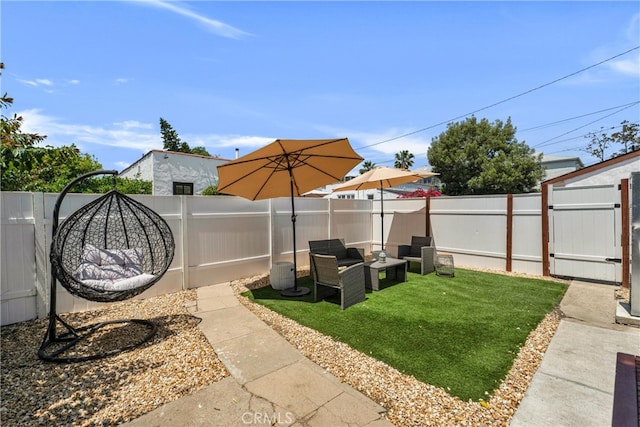 view of yard featuring an outdoor hangout area and a gate